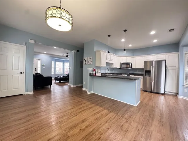 a view of kitchen with cabinets and stainless steel appliances