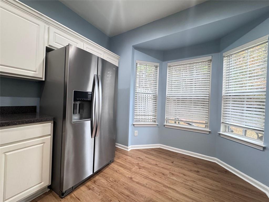 5495 Hampton Court Atlanta, GA 30349 - Photo 16 of 20 a kitchen with stainless steel appliances a refrigerator sink and cabinets