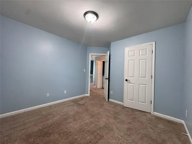 an empty room with closet and windows