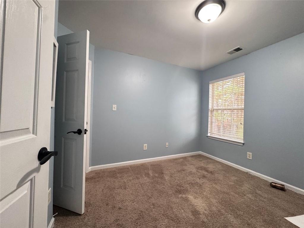 5495 Hampton Court Atlanta, GA 30349 - Photo 6 of 20 a view of an empty room with a window