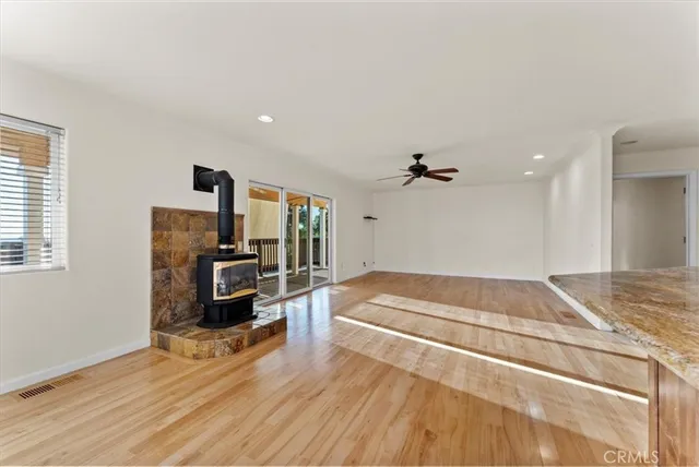 a kitchen with stainless steel appliances granite countertop a stove a sink dishwasher a refrigerator and a wooden cabinets