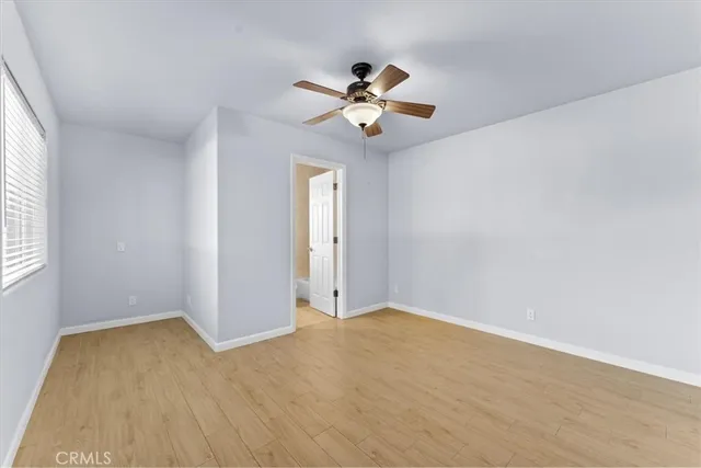 a view of a livingroom with a ceiling fan and wooden floor