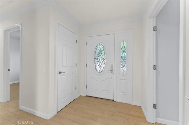 a view of a livingroom with wooden floor and a fireplace