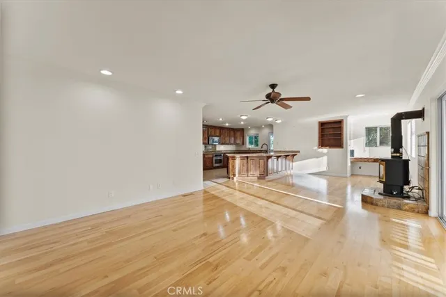 a view of a living room kitchen with a large window