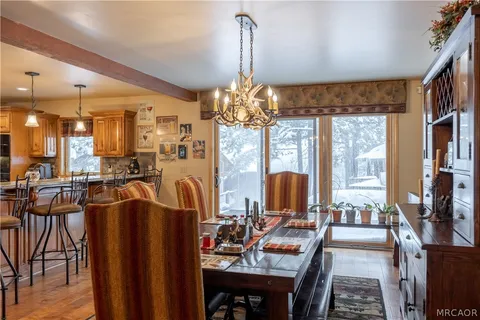 a view of a dining room with furniture large windows and wooden floor