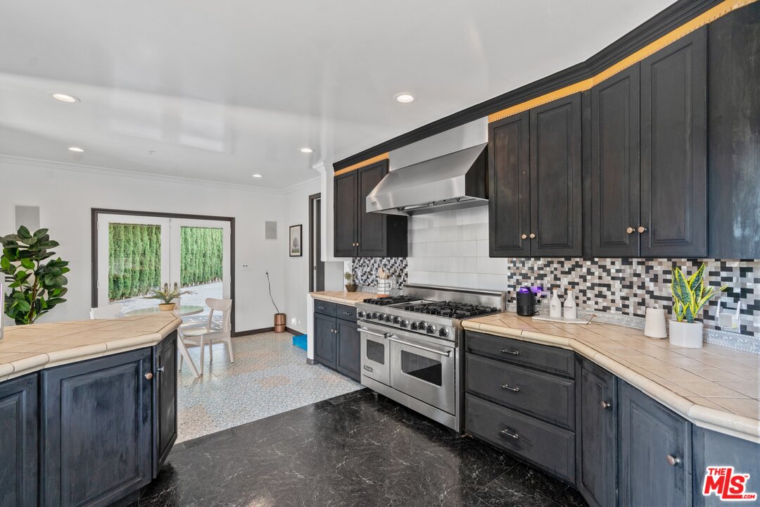 285 Barthe Drive Pasadena, CA 91103 - Photo 14 of 53 a kitchen with sink a stove and cabinets
