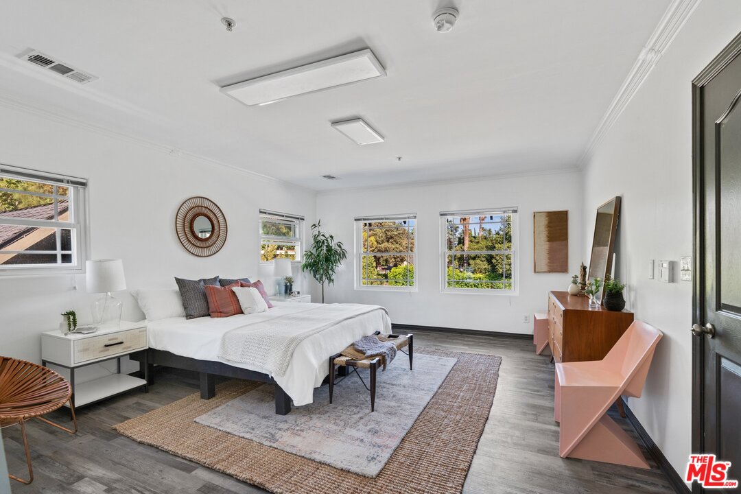 285 Barthe Drive Pasadena, CA 91103 - Photo 22 of 53 a bedroom with a bed a couch and a potted plant on the dresser