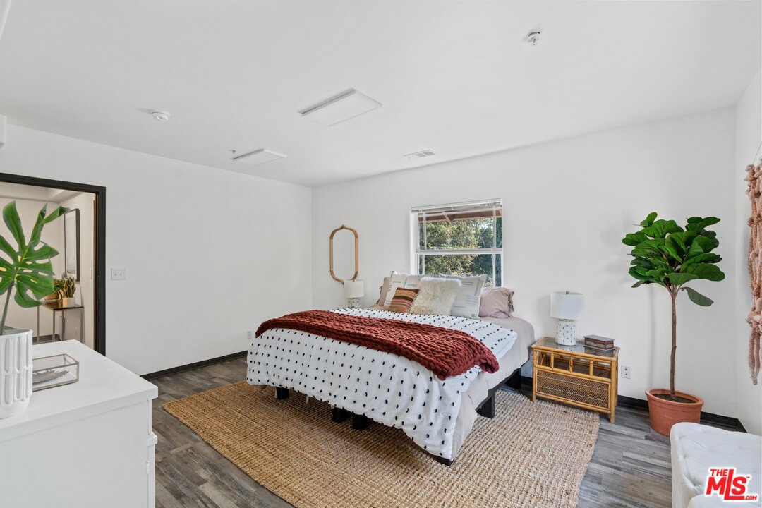 285 Barthe Drive Pasadena, CA 91103 - Photo 31 of 53 a bedroom with a bed and a potted plant