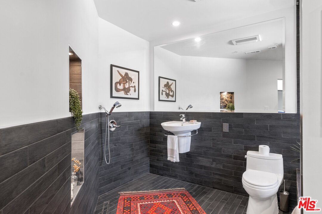 285 Barthe Drive Pasadena, CA 91103 - Photo 43 of 53 a spacious bathroom with a sink toilet a mirror and vanity