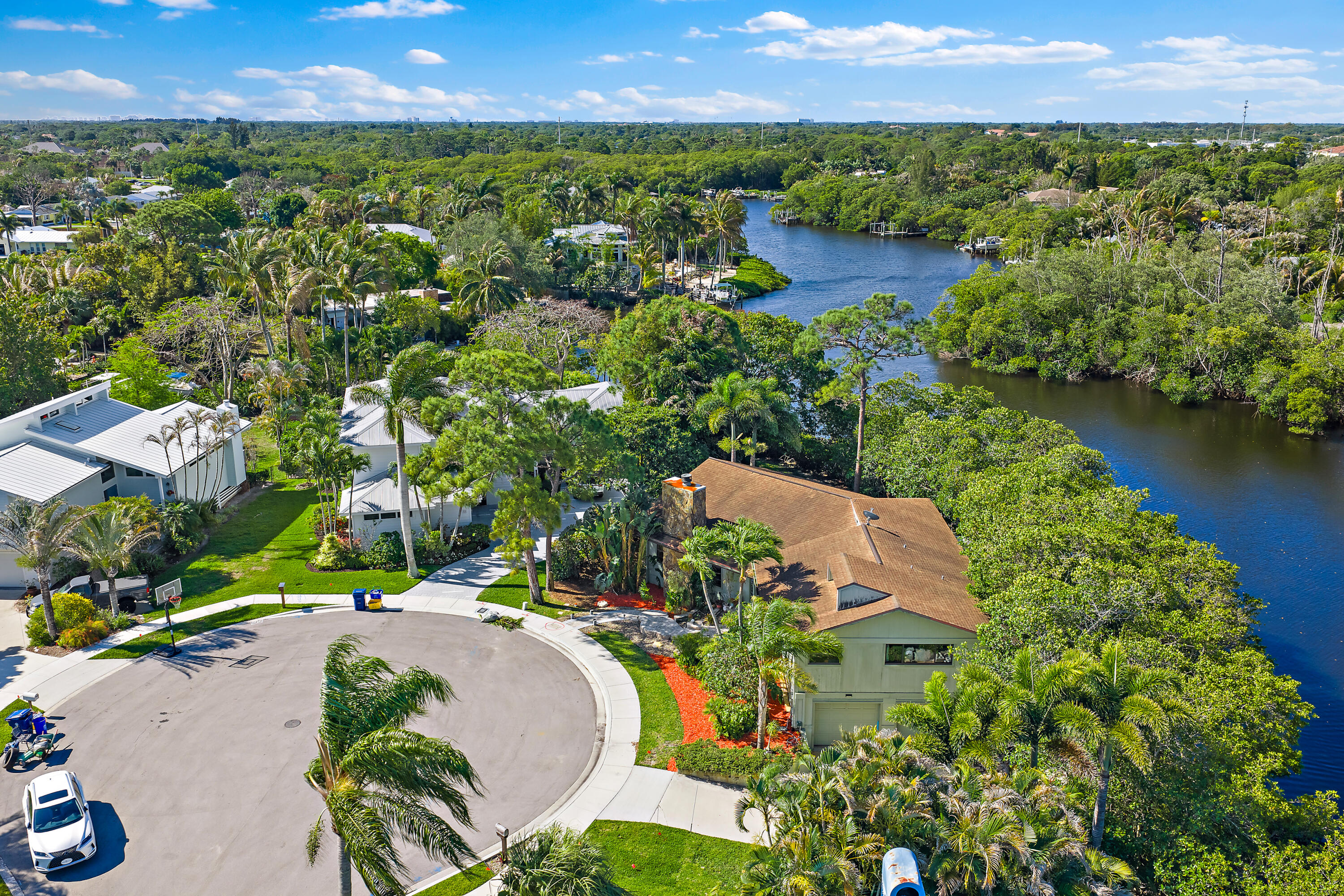 702 Warren Drive Jupiter, FL 33458 - Photo 10 of 76 an aerial view of a house with a garden and lake view