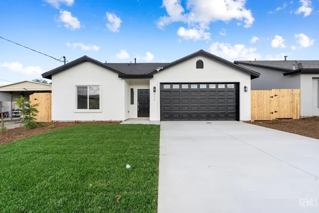a view of a house with a yard and garage