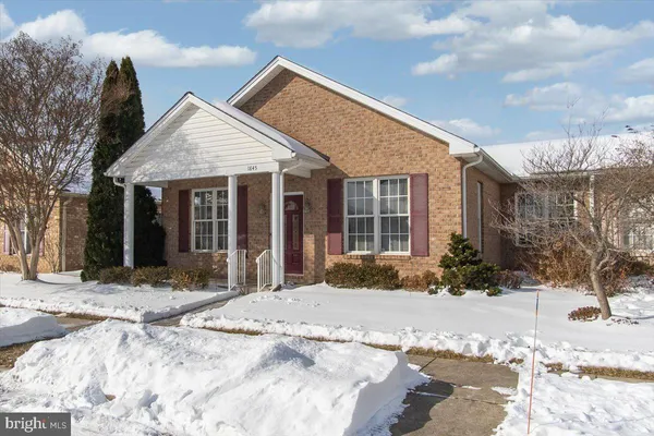 a view of a house with a yard covered in snow
