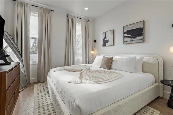 a bedroom with a bed and a tv