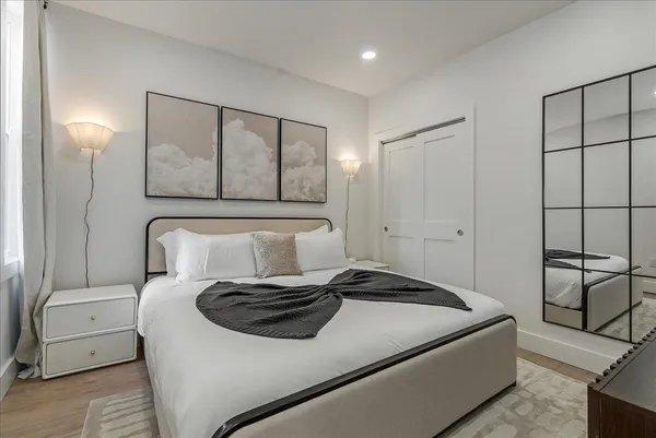 a bedroom with a bed and a flat screen tv