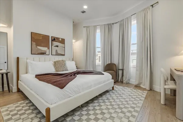 a bedroom with a bed and a couch