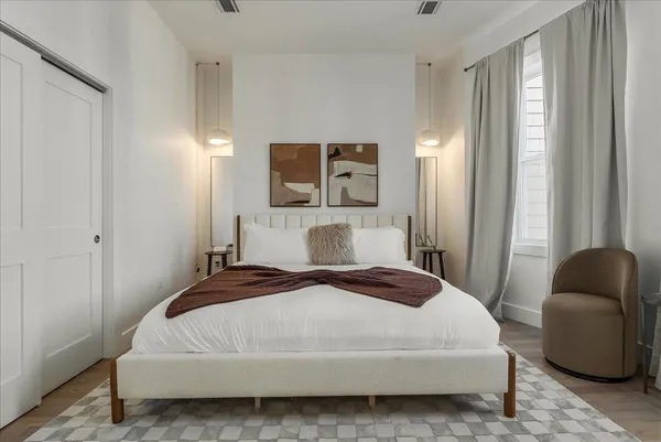 a bedroom with a bed and a chair