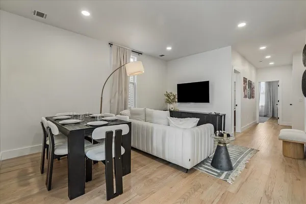 a view of a livingroom with furniture and a flat screen tv
