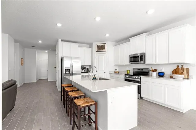 a large kitchen with a table and chairs
