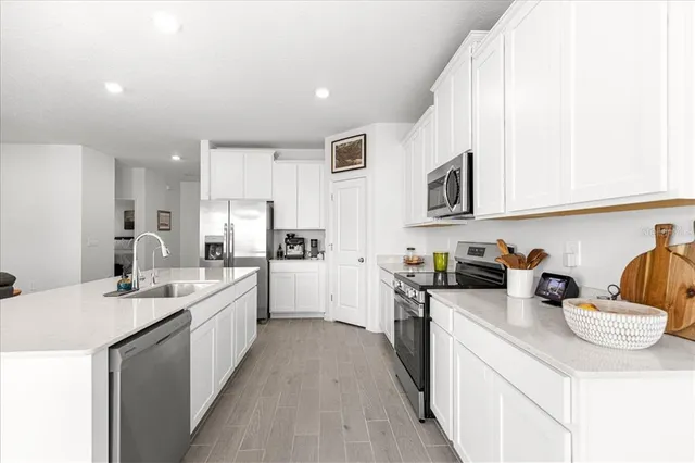 a large kitchen with a table and chairs
