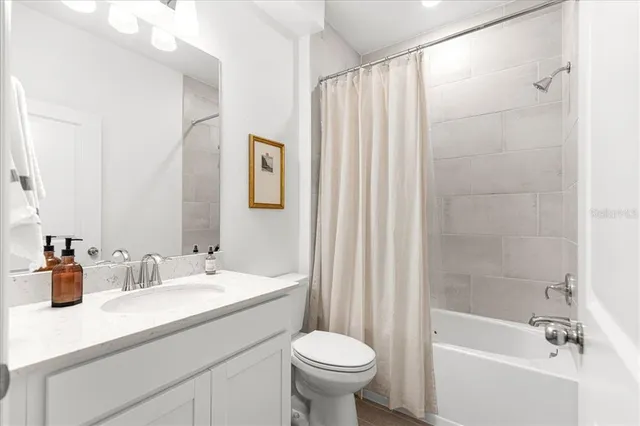 a bedroom with a bed and a potted plant