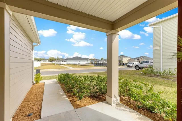 a view of a living room with a table and chairs
