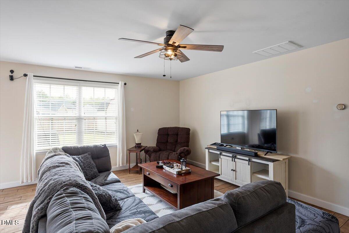 205 Battery Way Bunnlevel, NC 28323 - Photo 8 of 37 a living room with furniture and a flat screen tv