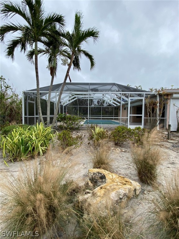 1399 Albatross Road Sanibel, FL 33957 - Photo 11 of 13 front view of a house with a yard and potted plants