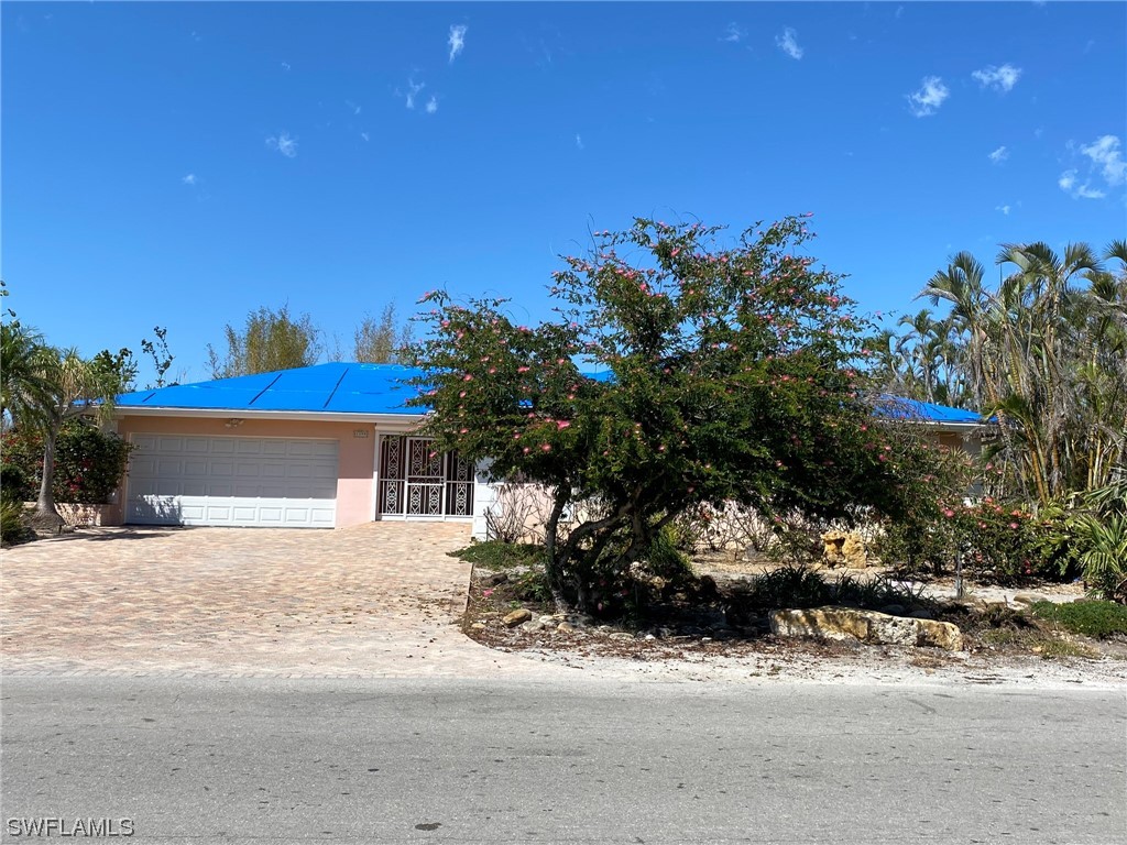 1399 Albatross Road Sanibel, FL 33957 - Photo 13 of 13 a backyard of a house with lots of green space