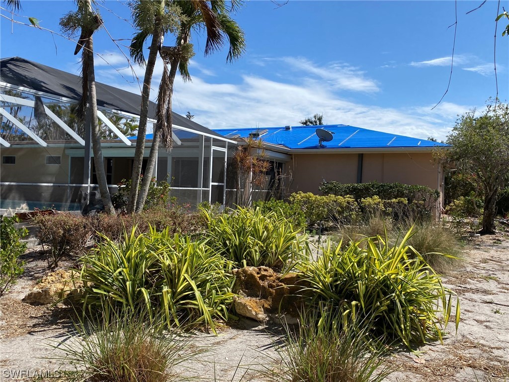 1399 Albatross Road Sanibel, FL 33957 - Photo 2 of 13 a front view of a house with garden