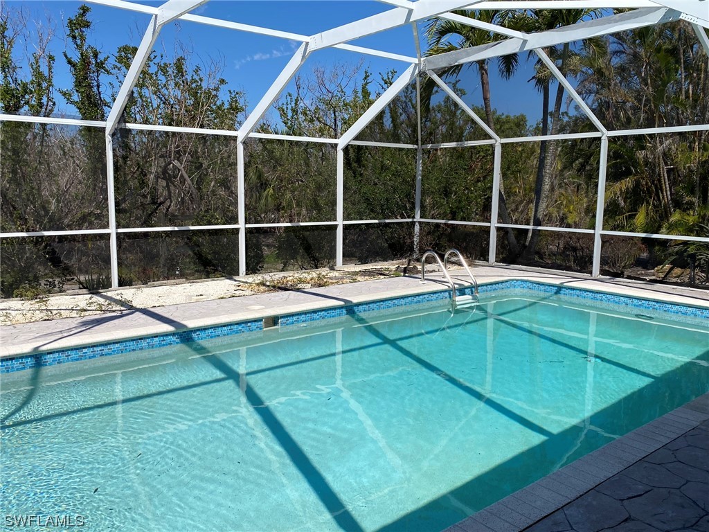 1399 Albatross Road Sanibel, FL 33957 - Photo 3 of 13 a view of a backyard with a patio and a small yard