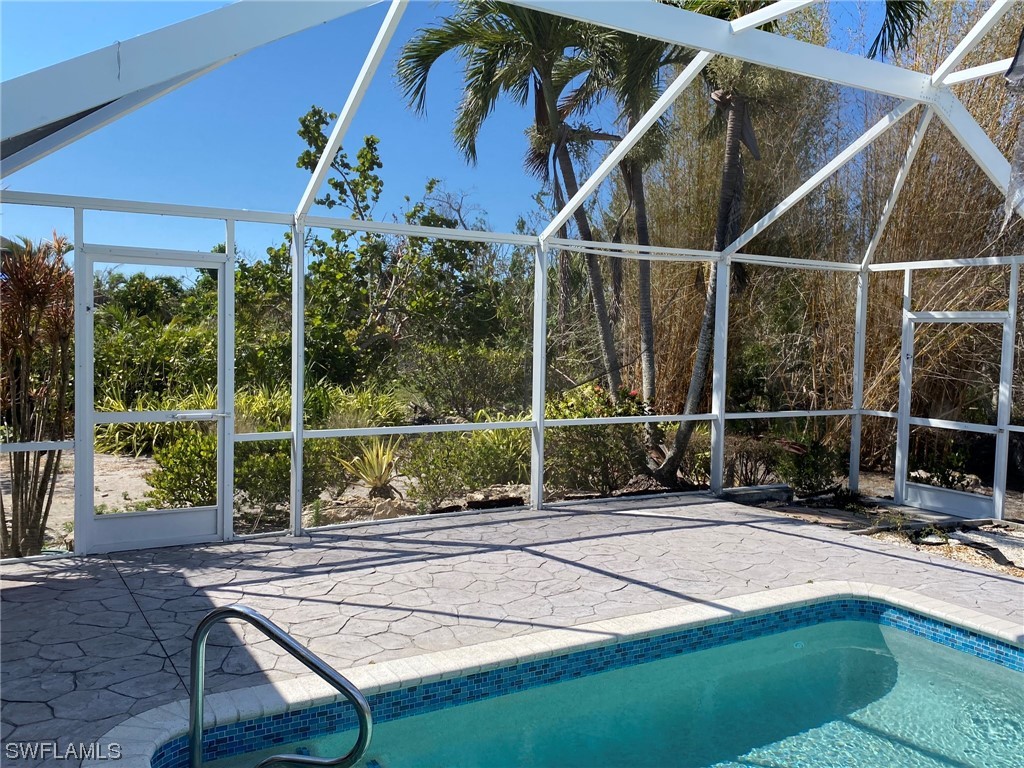1399 Albatross Road Sanibel, FL 33957 - Photo 8 of 13 a view of a chairs and table in the patio