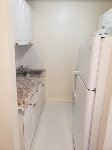 a bathroom with a granite countertop shower and a sink