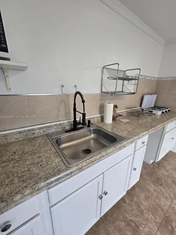 a kitchen with a sink and cabinets