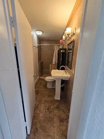 a bathroom with a shower and a toilet