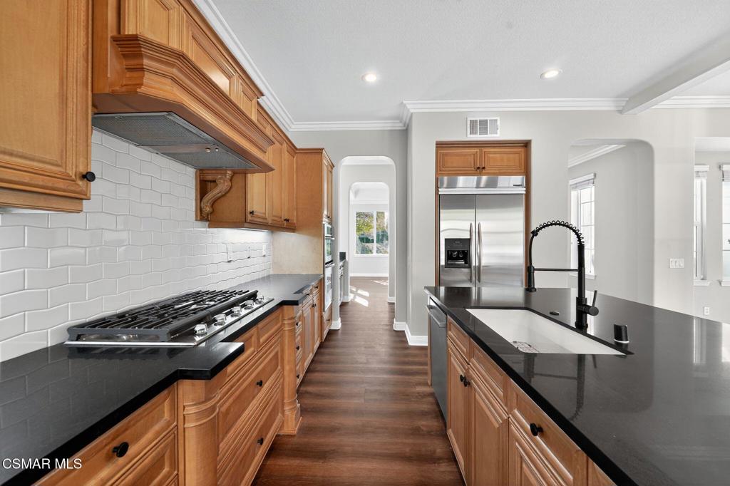2948 Milestone Avenue Simi Valley, CA 93065 - Photo 11 of 31 a kitchen with sink a stove and cabinets