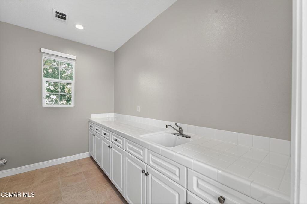 2948 Milestone Avenue Simi Valley, CA 93065 - Photo 18 of 31 a bathroom with a double vanity sink and a window