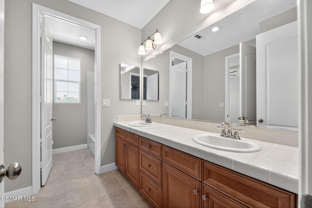 2948 Milestone Avenue Simi Valley, CA 93065 - Photo 23 of 31 a spacious bathroom with a sink double vanity and a mirror