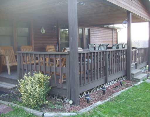 114 Rydle Road Mount Pleasant, PA 15666 - Photo 3 of 18 Patio/Deck. REAR DECK WITH TWO GATES WONDERFUL PLACE TO HAVE FAMILY OR FRIENDS FOR OUT DOOR FUN OVER LOOKING GREAT BACK YARD AND BARN TYPE BUILDING