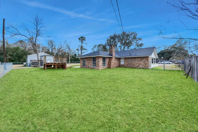 a view of a house with a big yard and potted plants