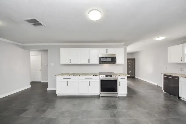 a view of a kitchen with a stove top oven