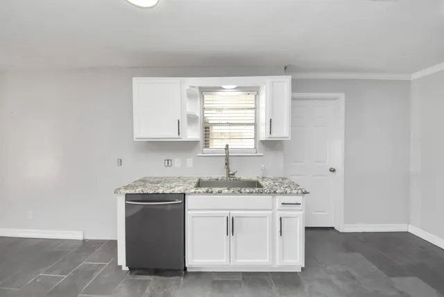 a kitchen with stainless steel appliances granite countertop a sink stove and cabinets