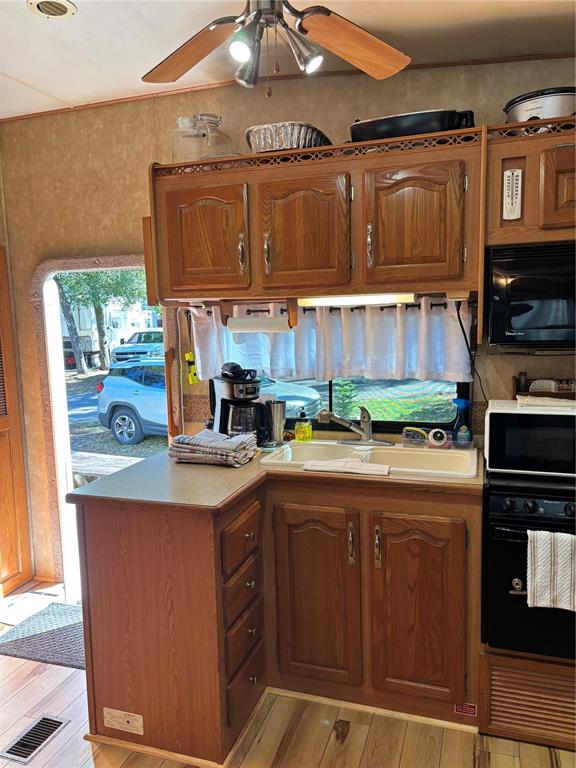 14348 Northeast 252nd Ct Road Fort McCoy, FL 32134 - Photo 21 of 51 a kitchen with stainless steel appliances granite countertop a sink and a stove