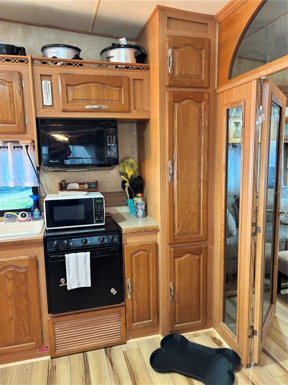 14348 Northeast 252nd Ct Road Fort McCoy, FL 32134 - Photo 22 of 51 a kitchen with stainless steel appliances granite countertop a stove and a refrigerator