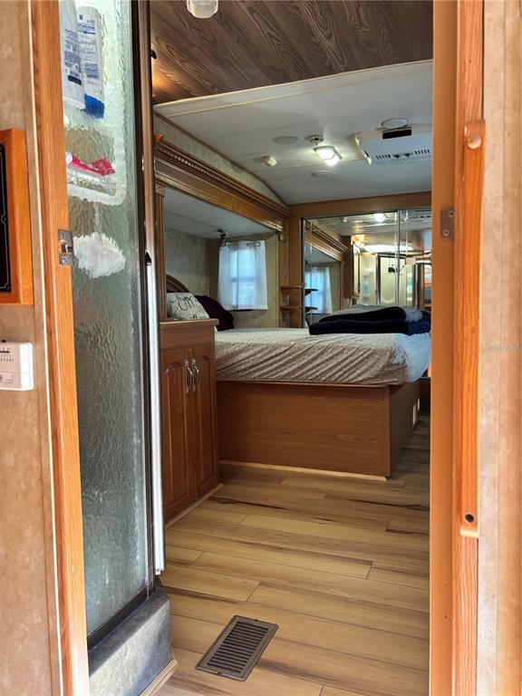 14348 Northeast 252nd Ct Road Fort McCoy, FL 32134 - Photo 29 of 51 a bedroom with a bed and a mirror