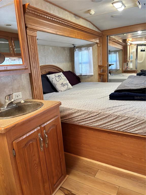 14348 Northeast 252nd Ct Road Fort McCoy, FL 32134 - Photo 30 of 51 a bedroom with a bed and a large mirror