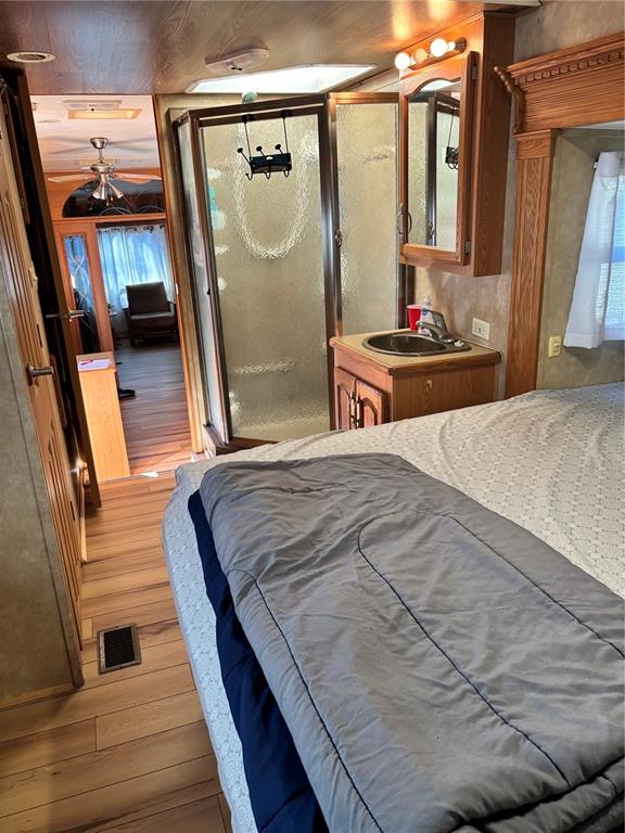 14348 Northeast 252nd Ct Road Fort McCoy, FL 32134 - Photo 32 of 51 a bedroom with a bed and a mirror