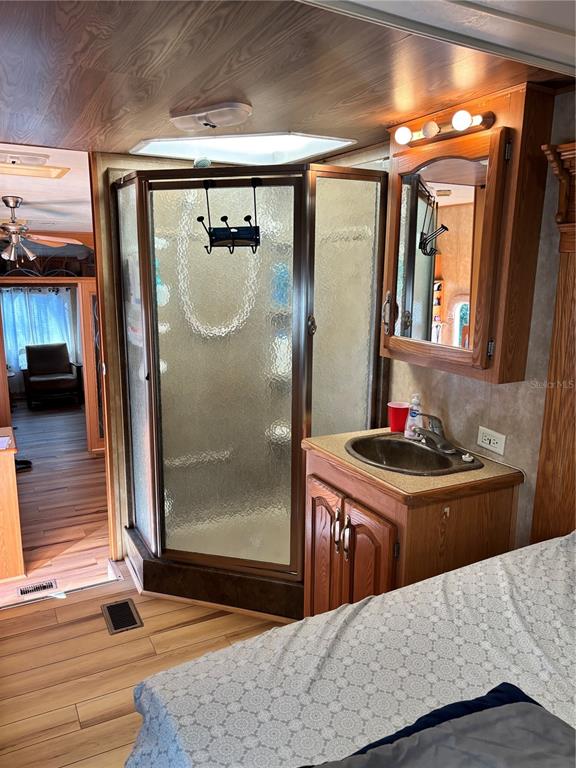 14348 Northeast 252nd Ct Road Fort McCoy, FL 32134 - Photo 33 of 51 a bedroom with a bed and a mirror