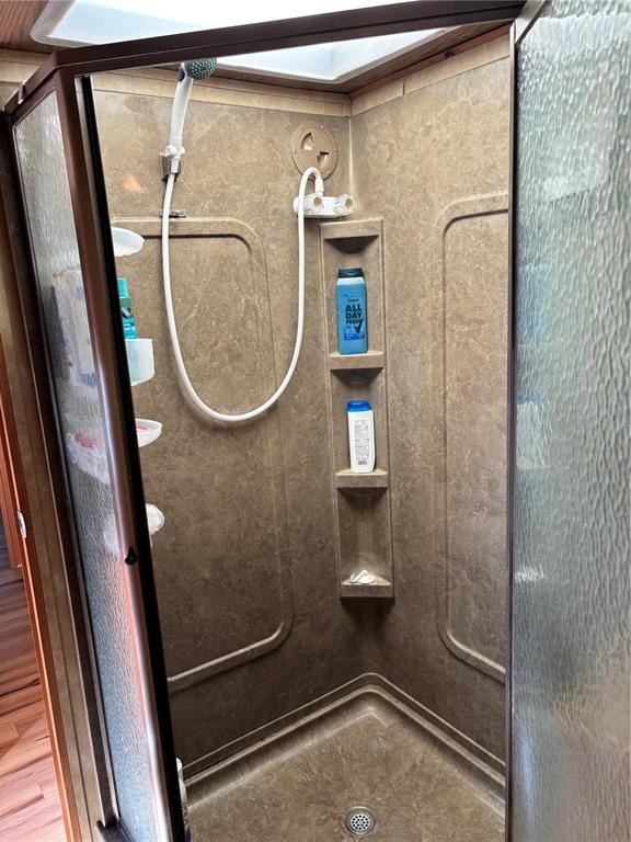 14348 Northeast 252nd Ct Road Fort McCoy, FL 32134 - Photo 35 of 51 a bathroom with a glass shower door and mirror