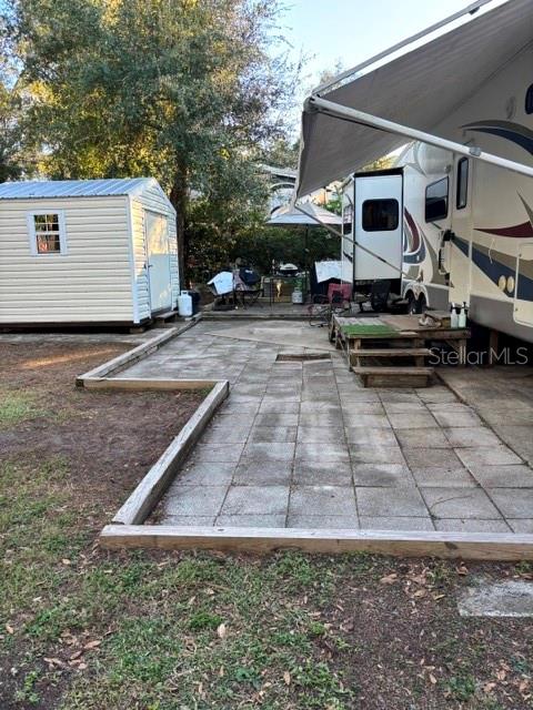 14348 Northeast 252nd Ct Road Fort McCoy, FL 32134 - Photo 4 of 51 a backyard of a house with barbeque oven table and chairs