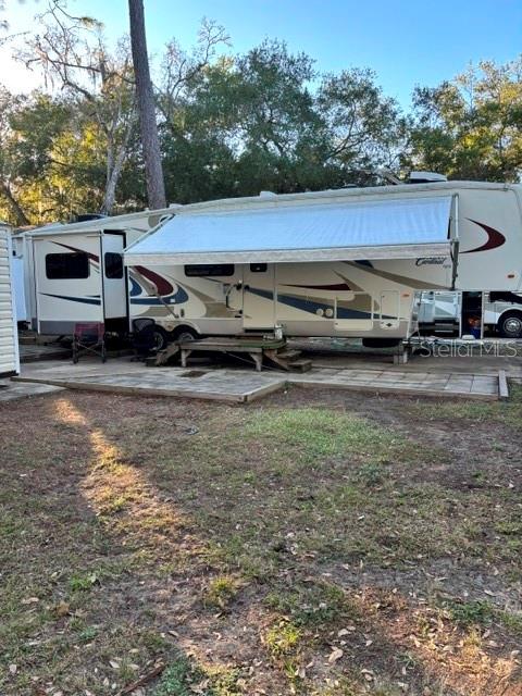 14348 Northeast 252nd Ct Road Fort McCoy, FL 32134 - Photo 5 of 51 a view of a car park in front of a house